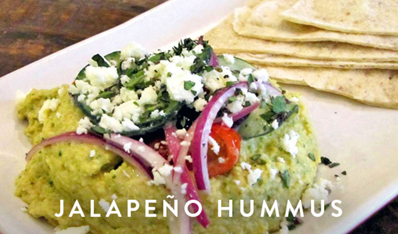 jalapeño recipes: jalapeno hummus on a plate with pita