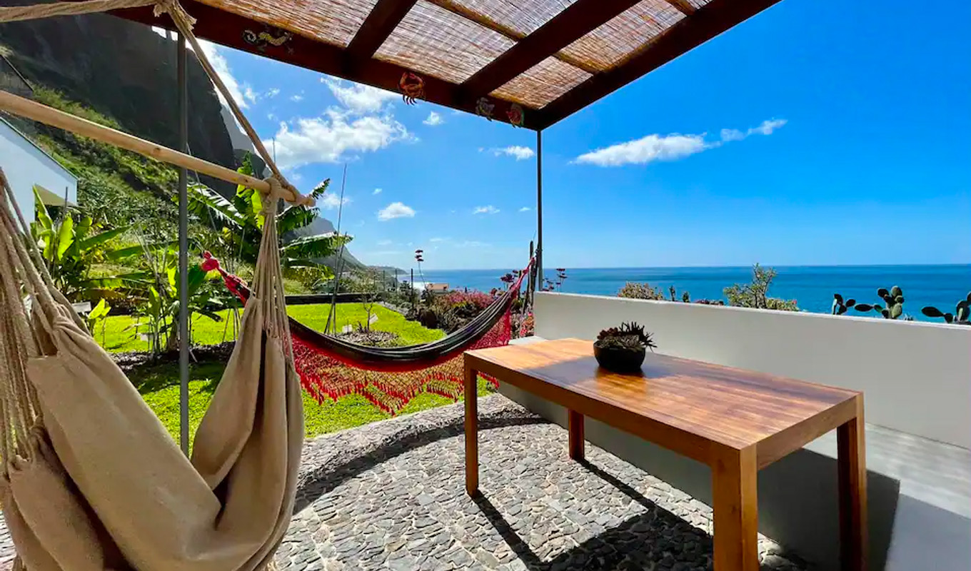 best airbnbs in portugal: hammocks and table at Meu Pé de Cacau in Paúl do Mar, Madeira