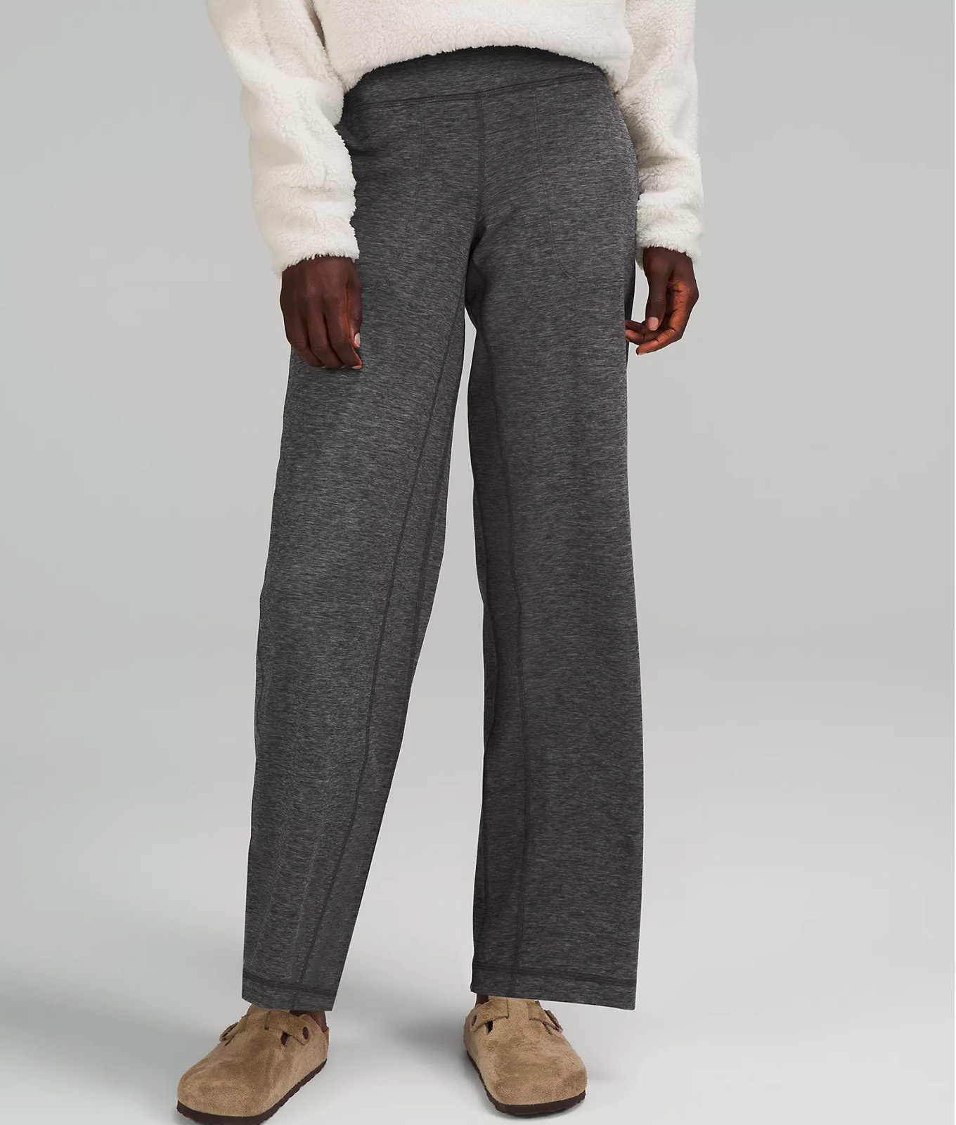 Lululemon model wearing Birkenstocks, gray wide leg leggings and sherpa sweater.