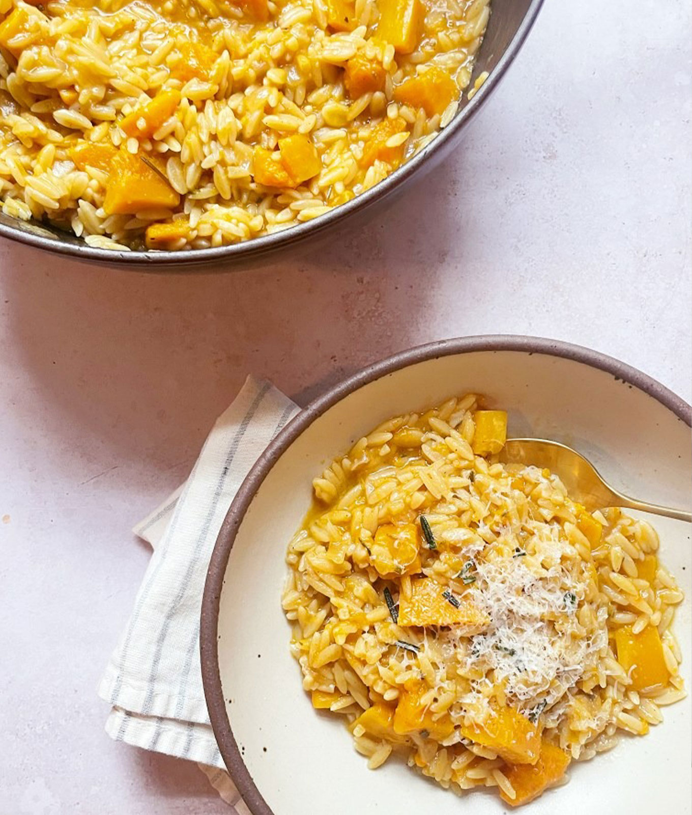 two bowls of orzotto with winter squash and rosemary