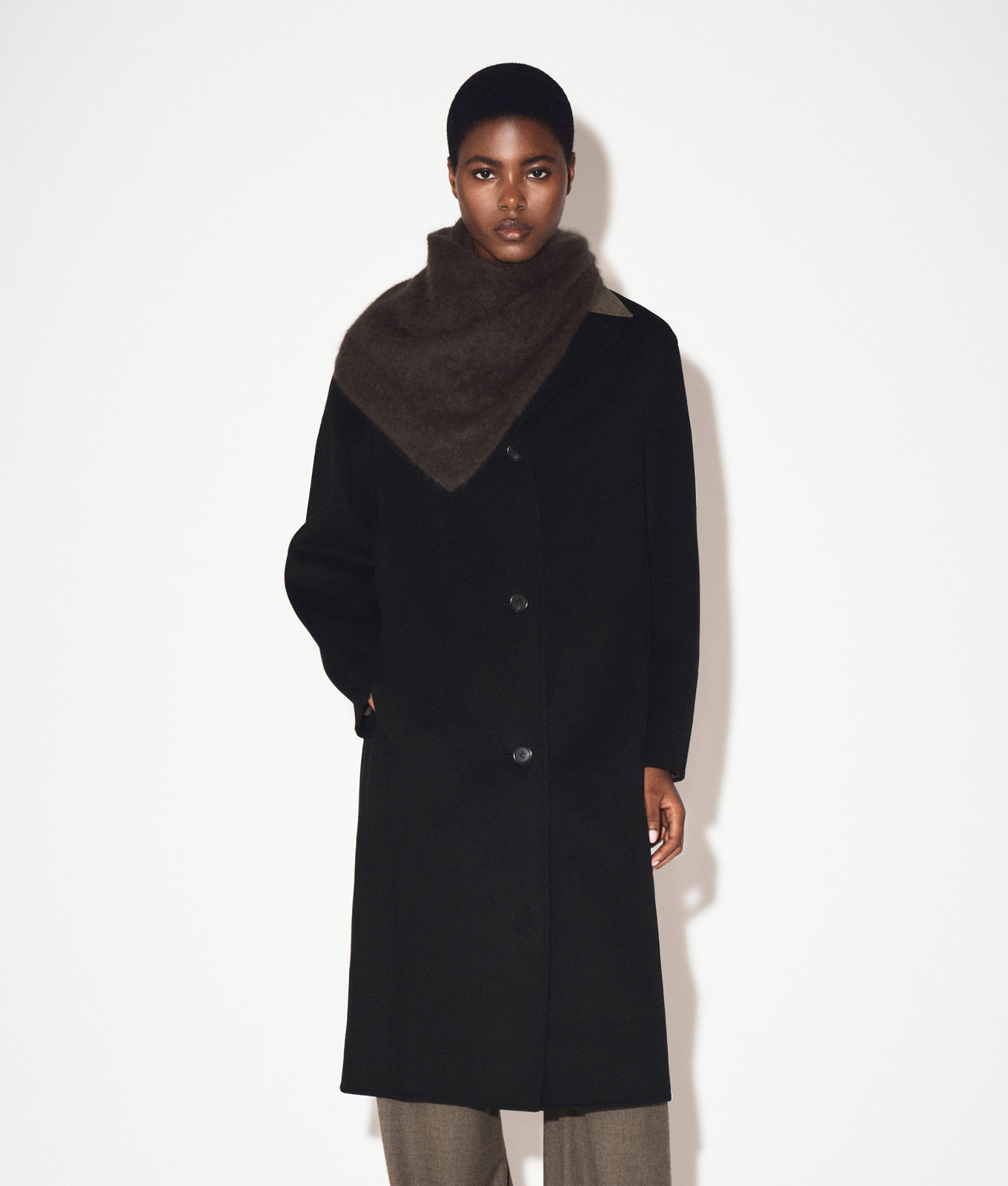 A woman models the COS double-faced wool coat on sale for black friday.