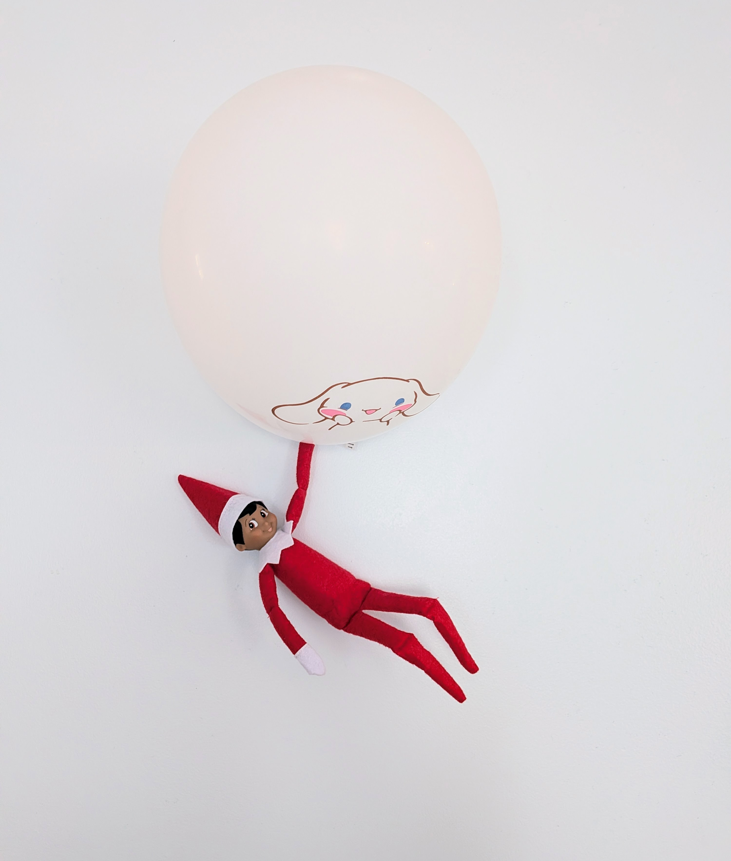 easy elf on the shelf ideas: elf hanging from a balloon