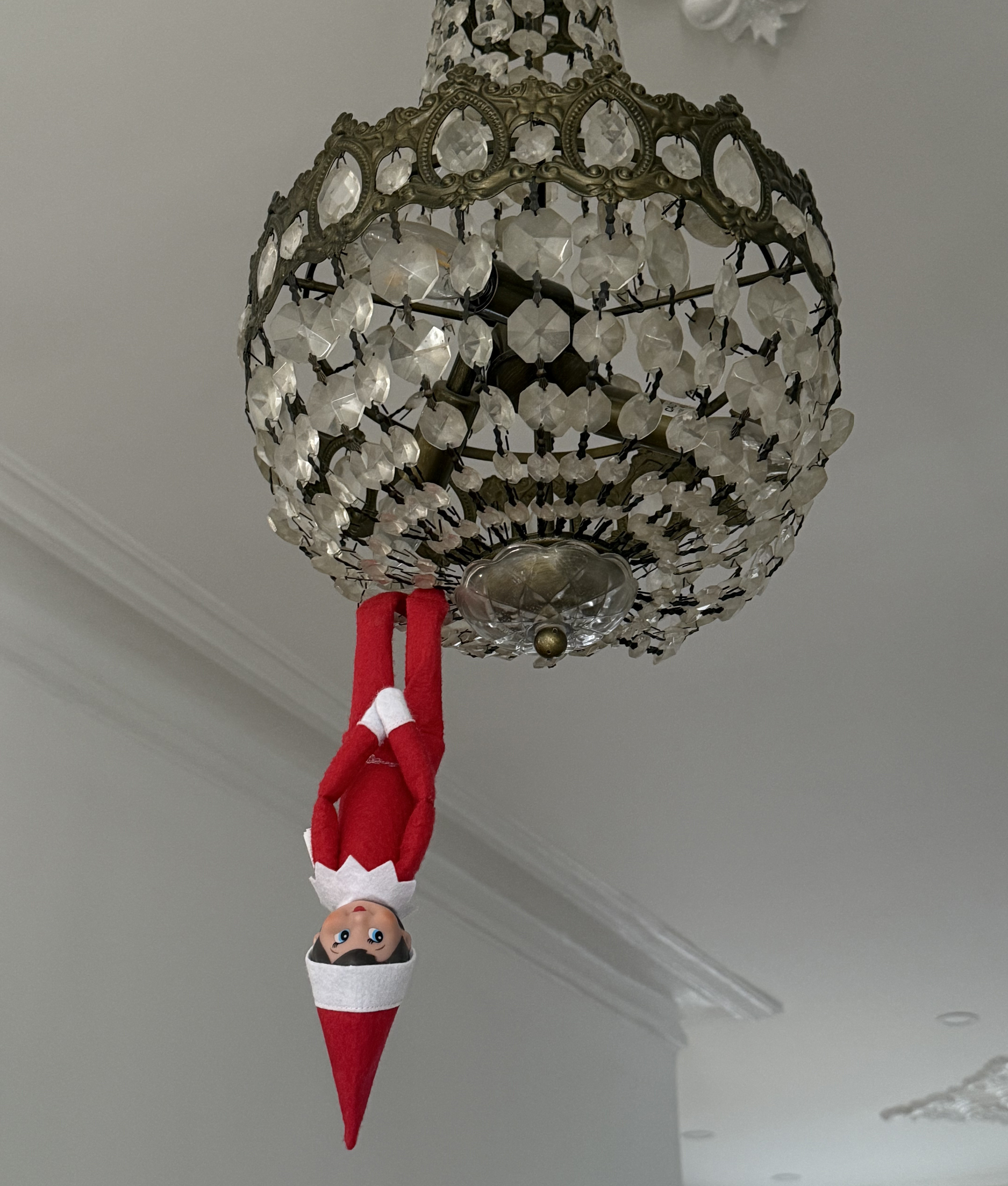 easy elf on the shelf ideas: hang it from chandelier