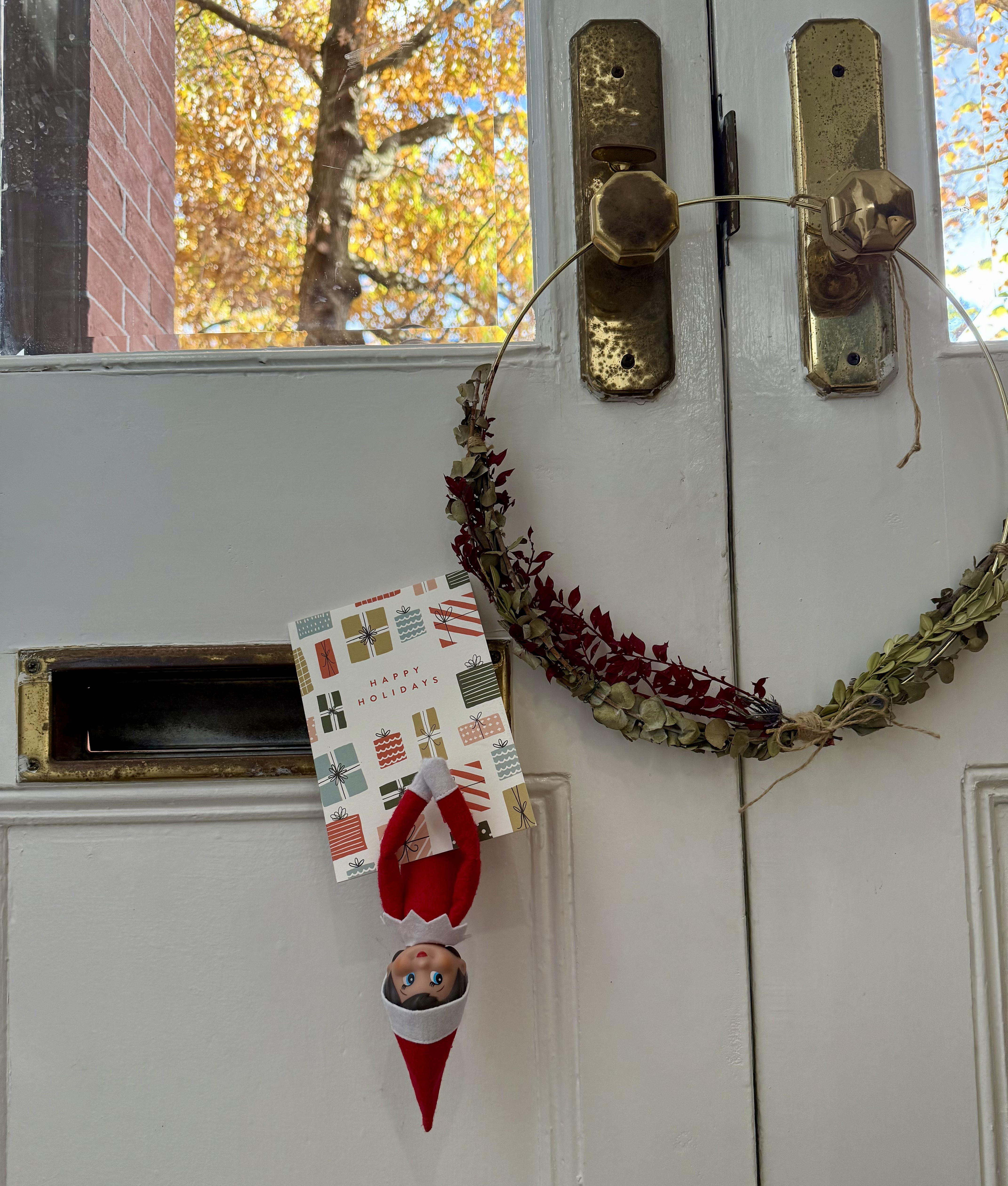 mailbox with elf hanging from it
