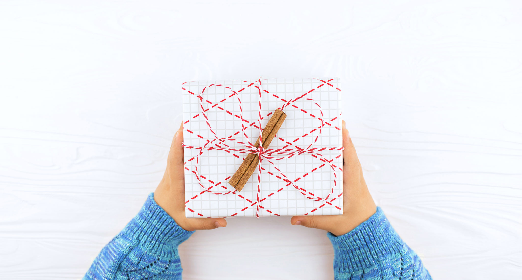 how-much-to-gift-teachers-for-holidays: a child holding a wrapped present