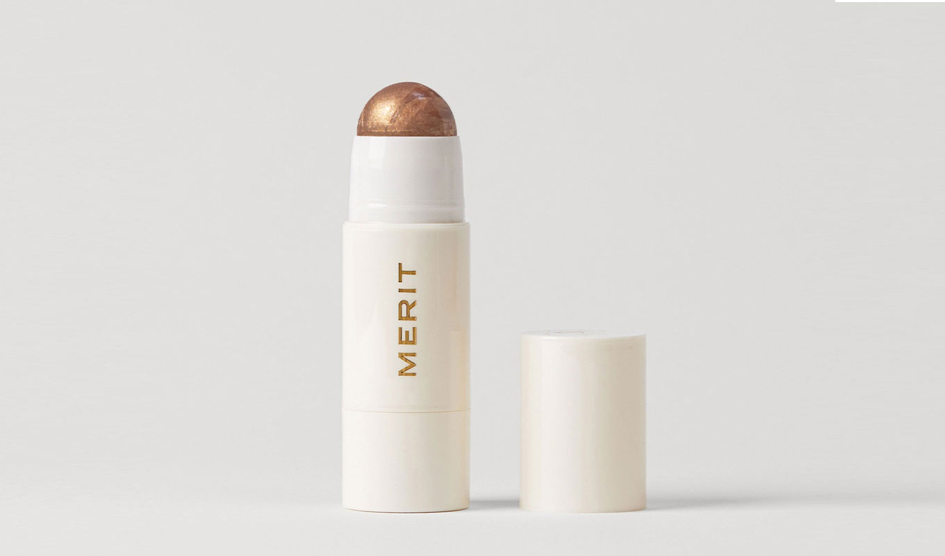 merit-beauty-black-friday: merit beauty's gold highlighting balm stick