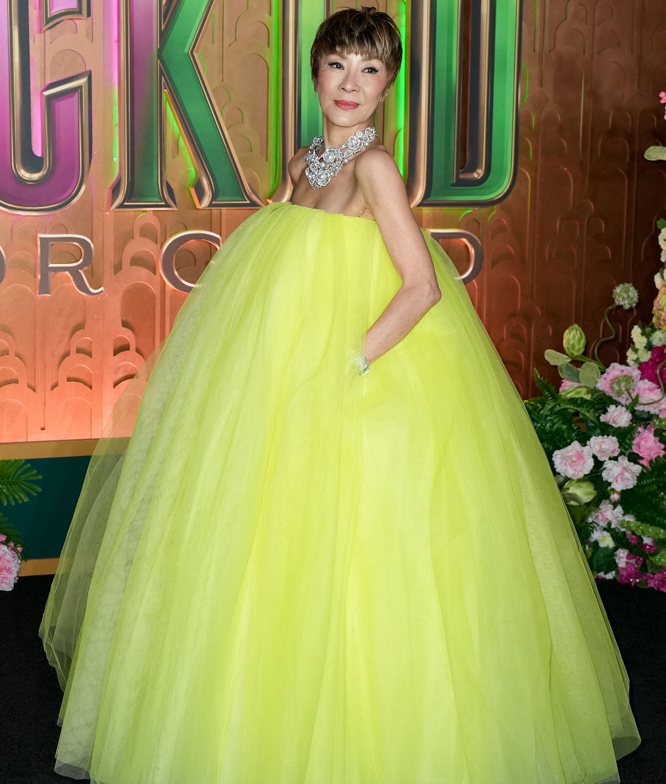 michelle yeoh pixie haircut: michelle yeoh in pixie cut and yellow puffy dress at NYC wicked premiere
