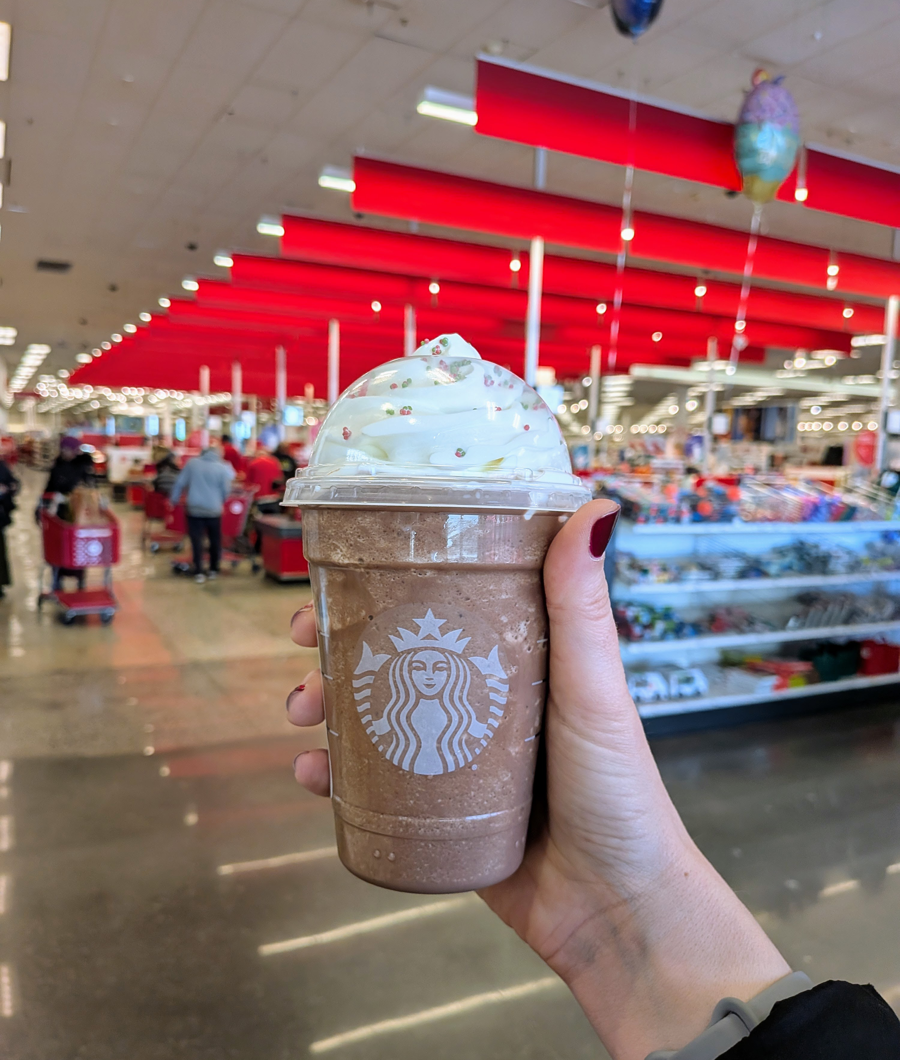 holding up the starbucks peppermint frozen hot chocolate inside a target store