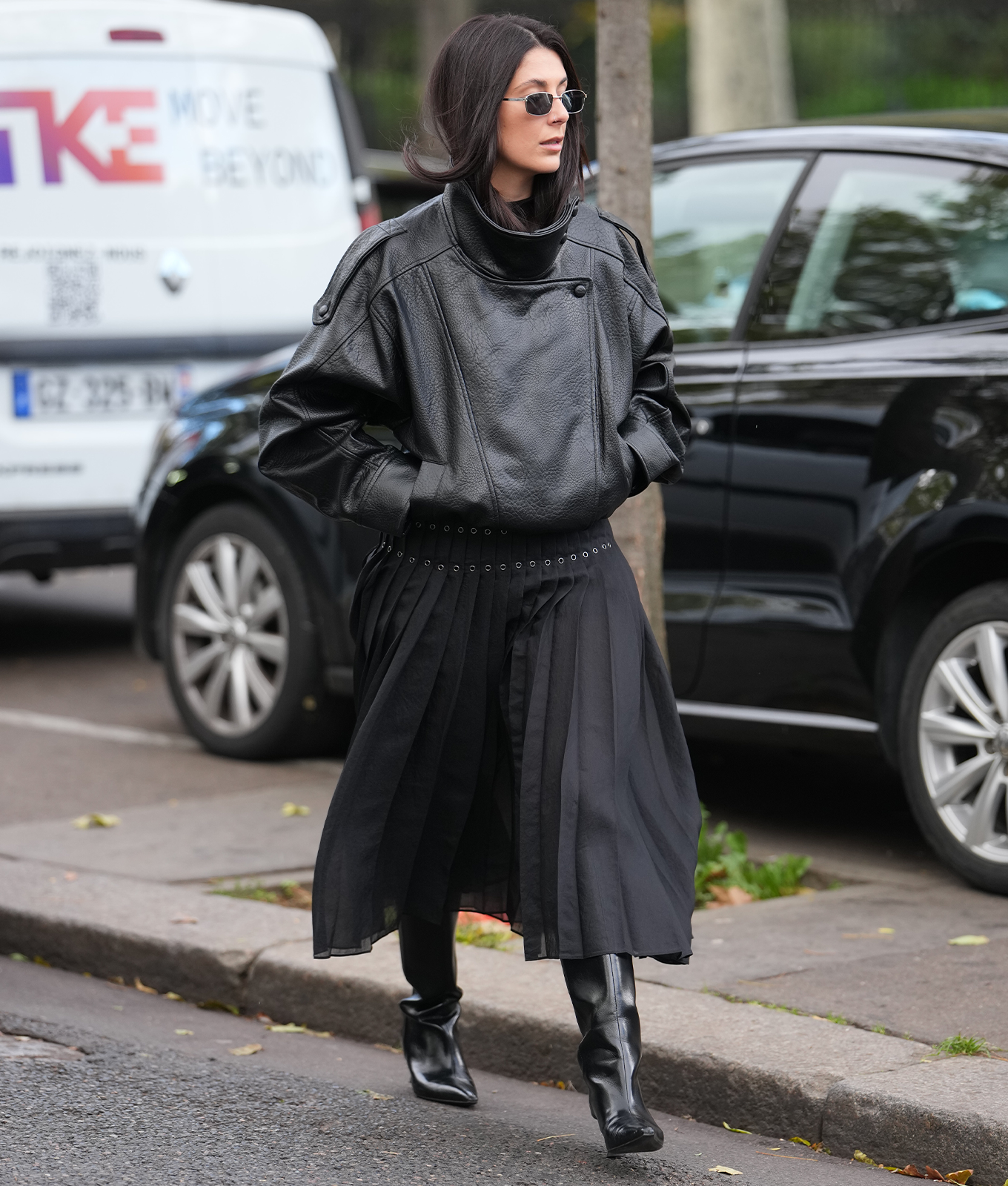 woman wearing a leather bomber jacket with an a line skirt