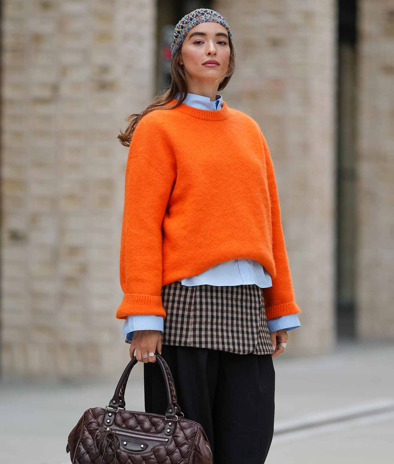 woman wearing citrus orange winter color trends 2026