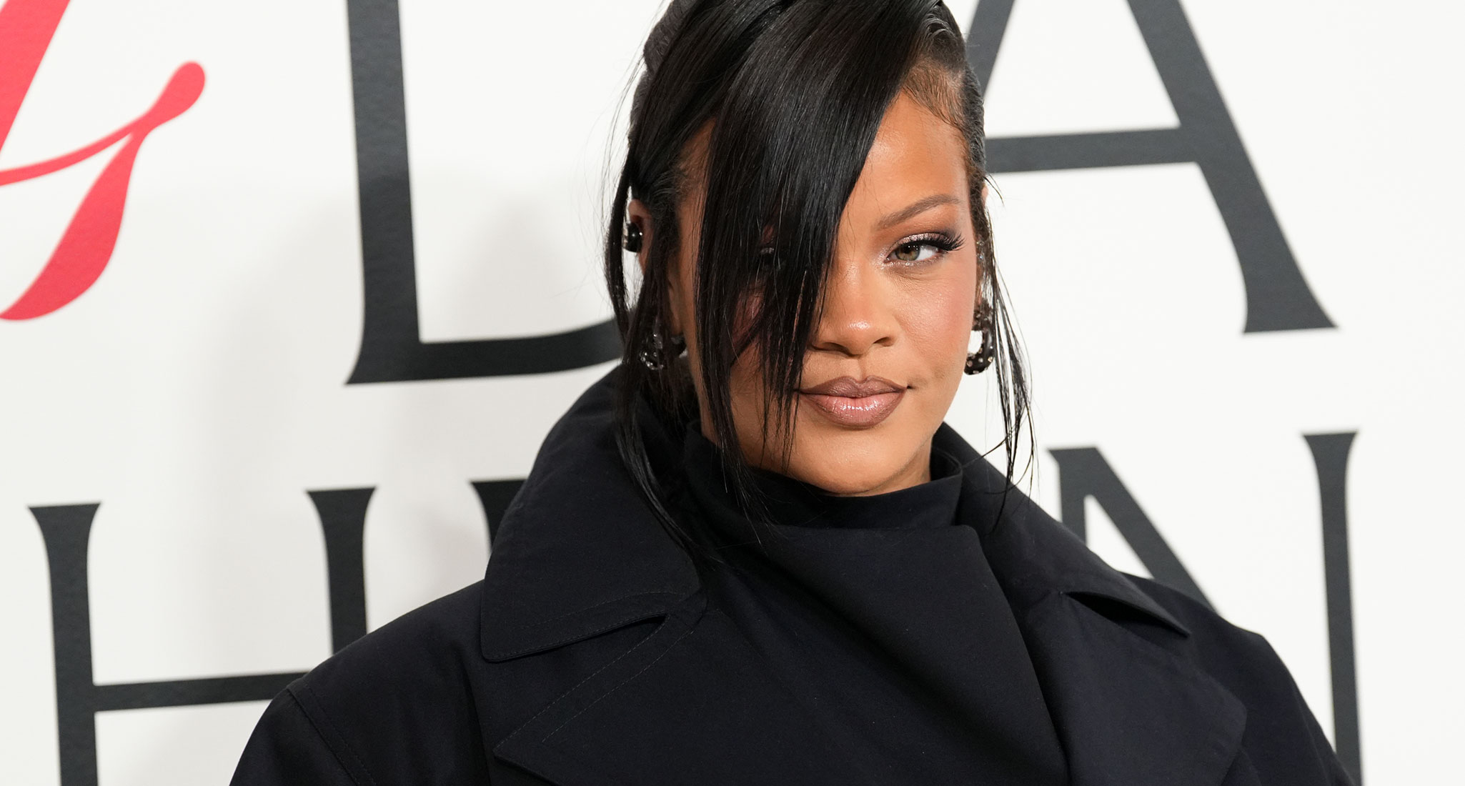 a photo of rihanna with a black coat
