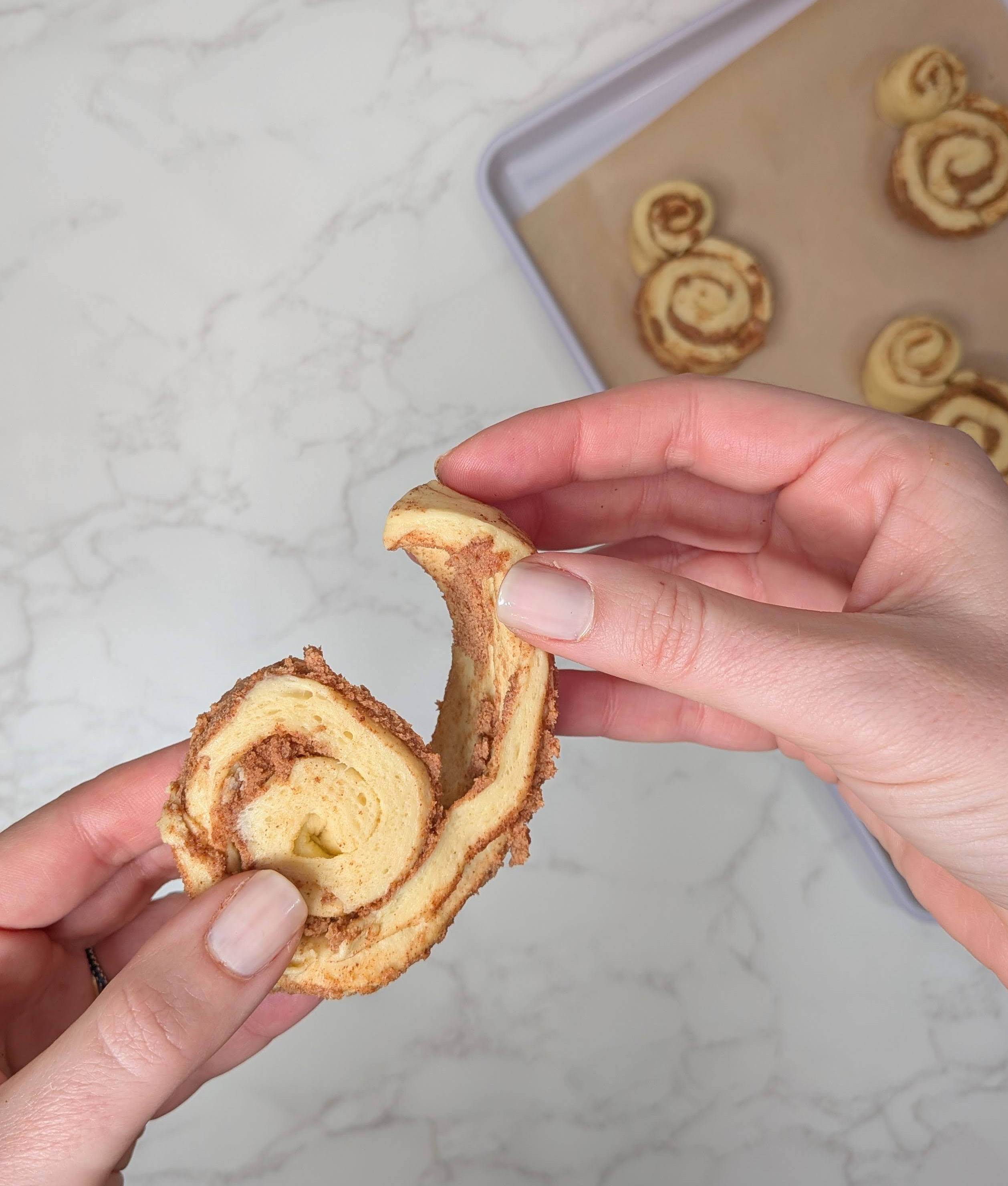 unraveling cinnamon roll dough