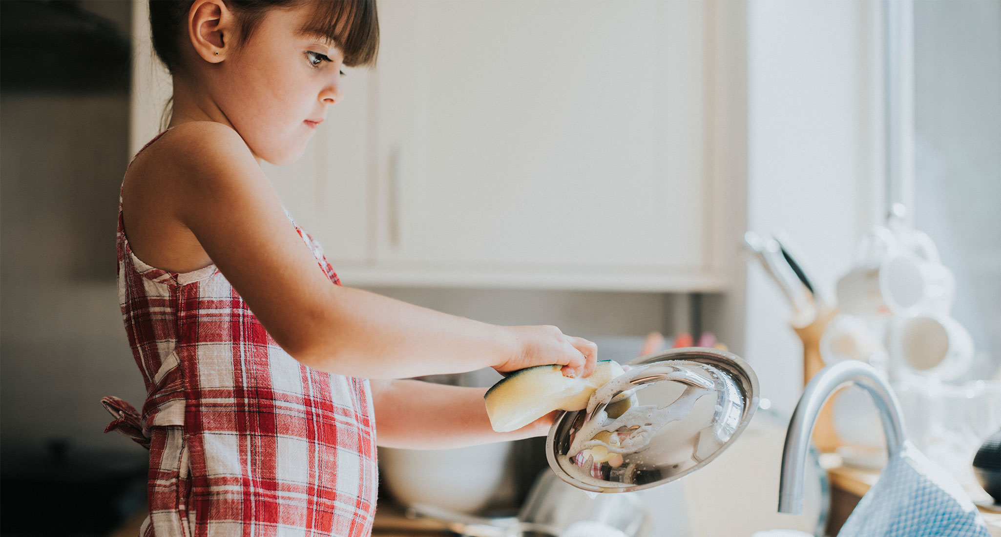i-hold-my-son-and-daughter-to-different-standards: a young girl washing dishes