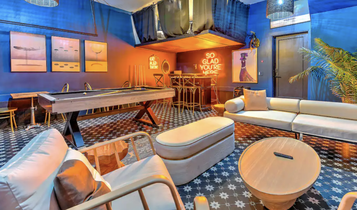 airbnb with pool table and neon sign