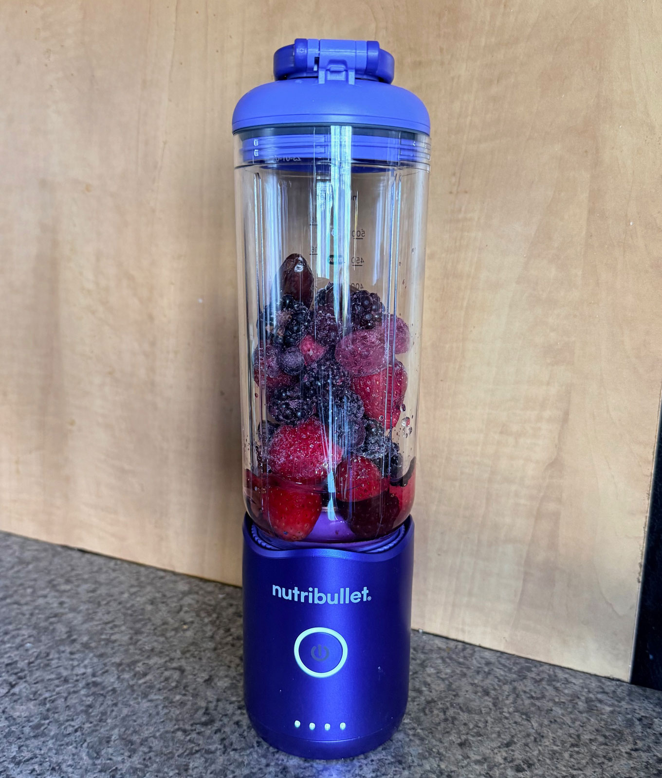 NutriBullet Flex Portable Blender Review: Original photo by Stephanie Maida of blender with frozen berries in it