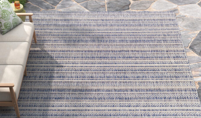 The Kelly Clarkson Home Valentin Striped Blue/Charcoal Indoor and Outdoor Area Rug.