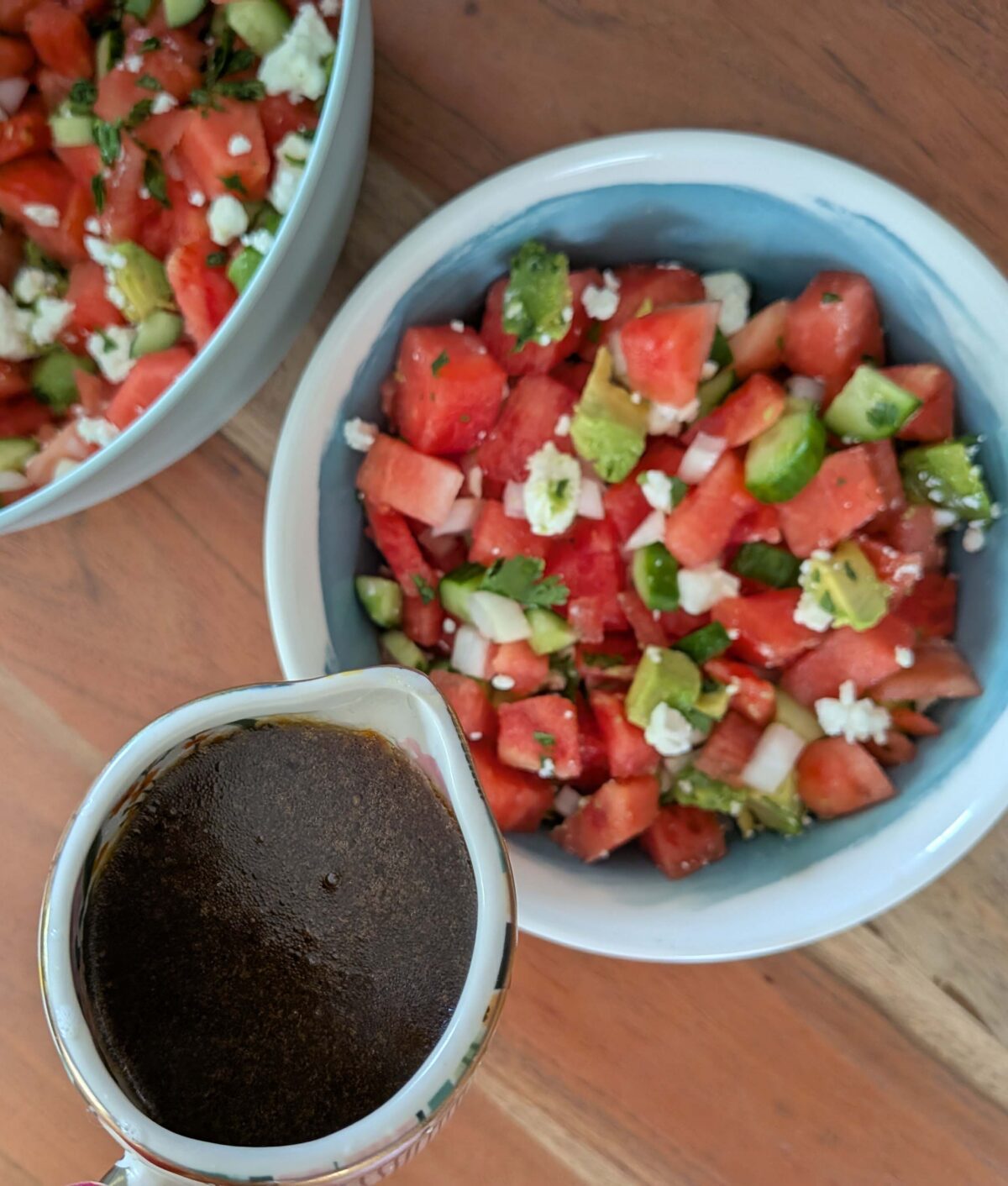adding dressing to watermelon salad