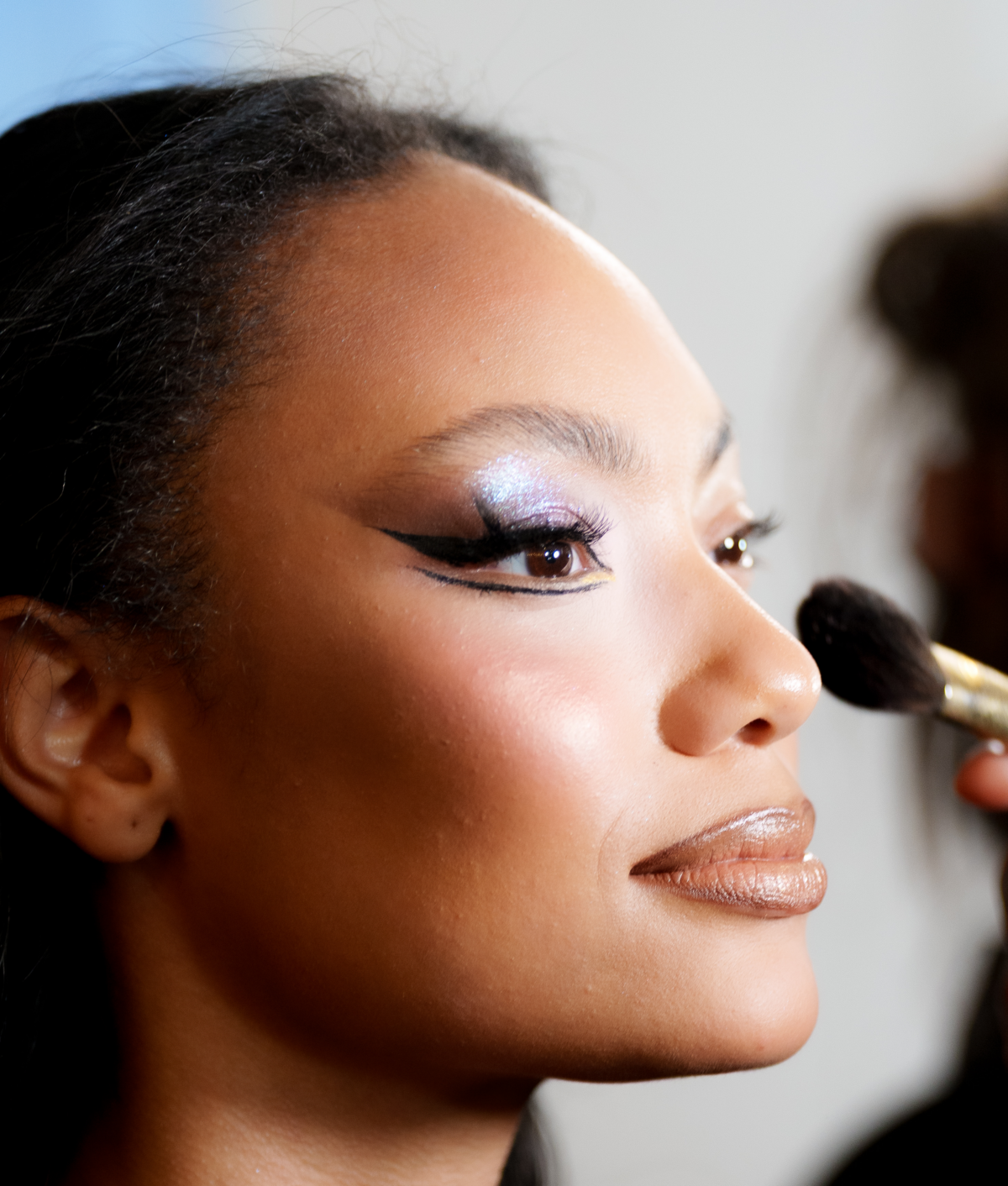 model getting eyeliner at nyfw