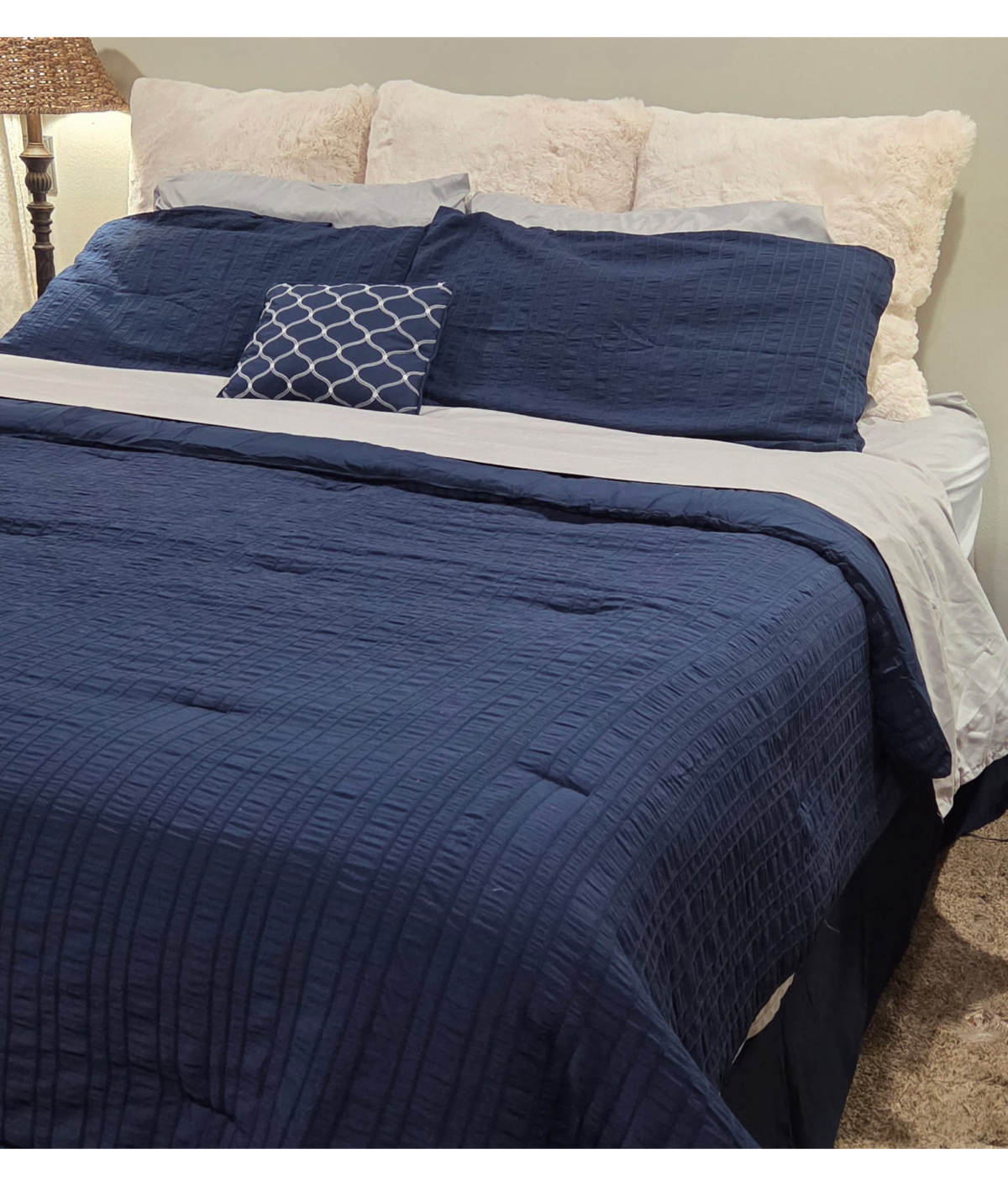 sealy mattress with navy comforter and white pillows