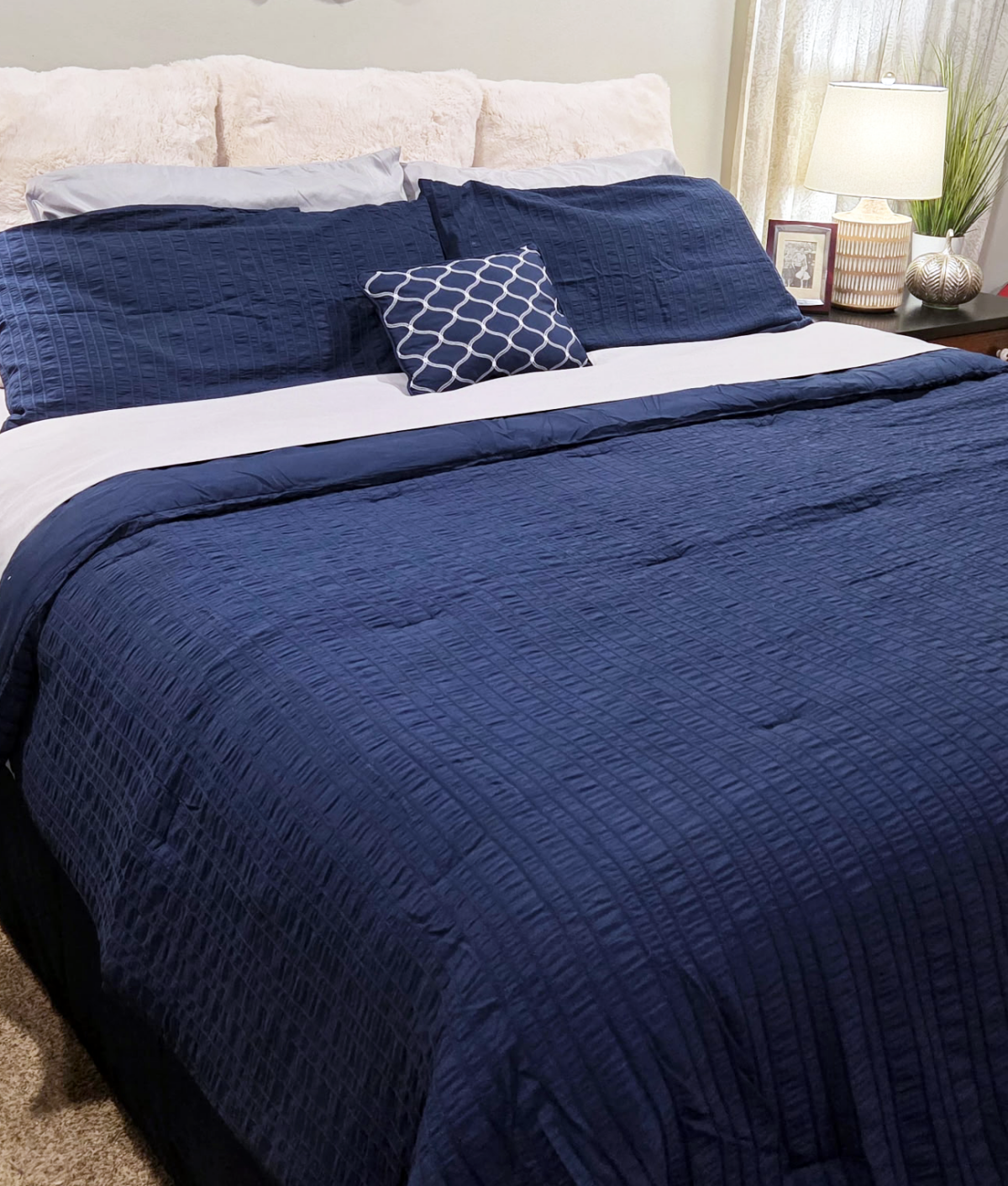 sealy mattress with navy bedding on it