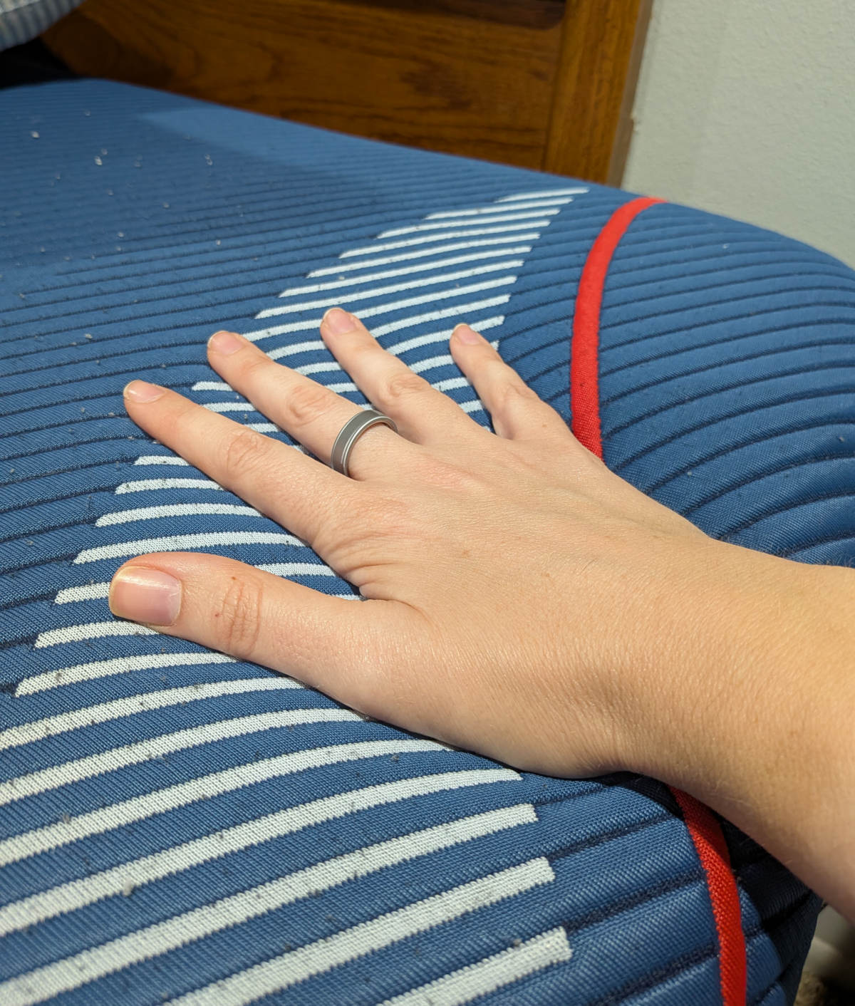 hand on mattress to test firmness