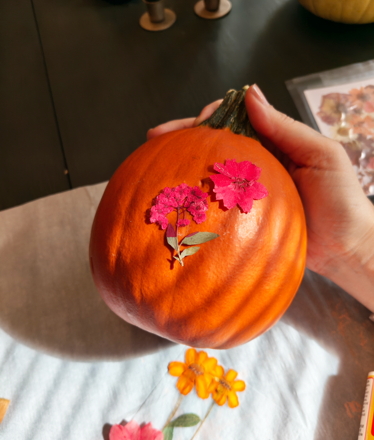 arrange flowers on pumpkin